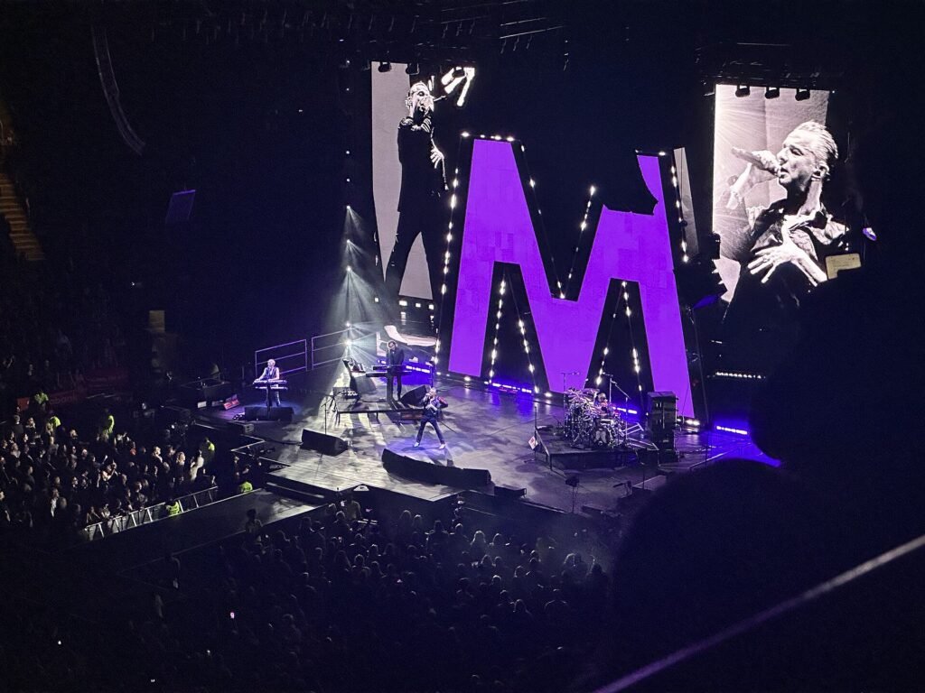 Depeche Mode on stage at Scotiabank Arena in Toronto in 2023, with Dave Gahan on the big screen