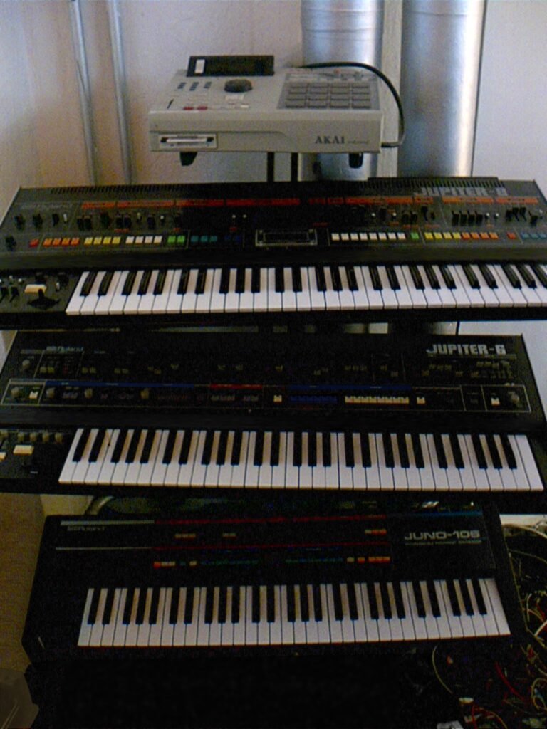 Roland Jupiter-8 synthesizer stacked with a Jupiter-6 and Juno-106 in a home studio rack