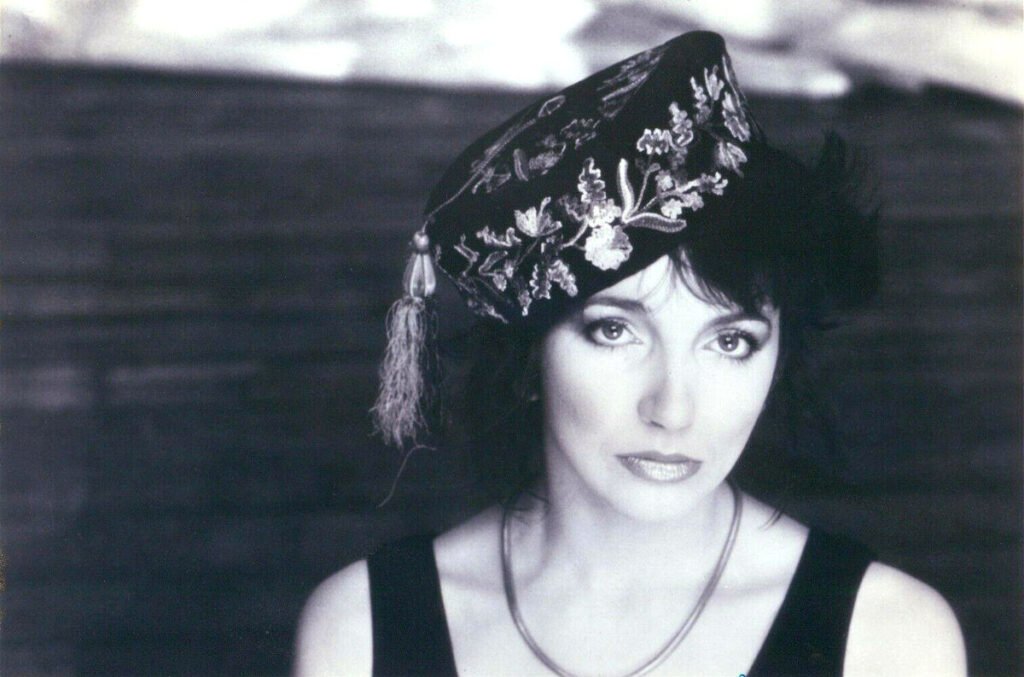 Kate Bush wearing an embroidered cap in a 1985 EMI publicity photo