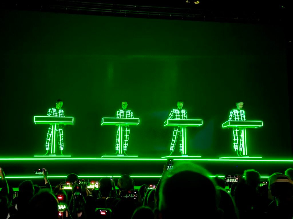 Four green-lit robot figures on stage during Kraftwerk's Multimedia Tour in Bangkok in 2026