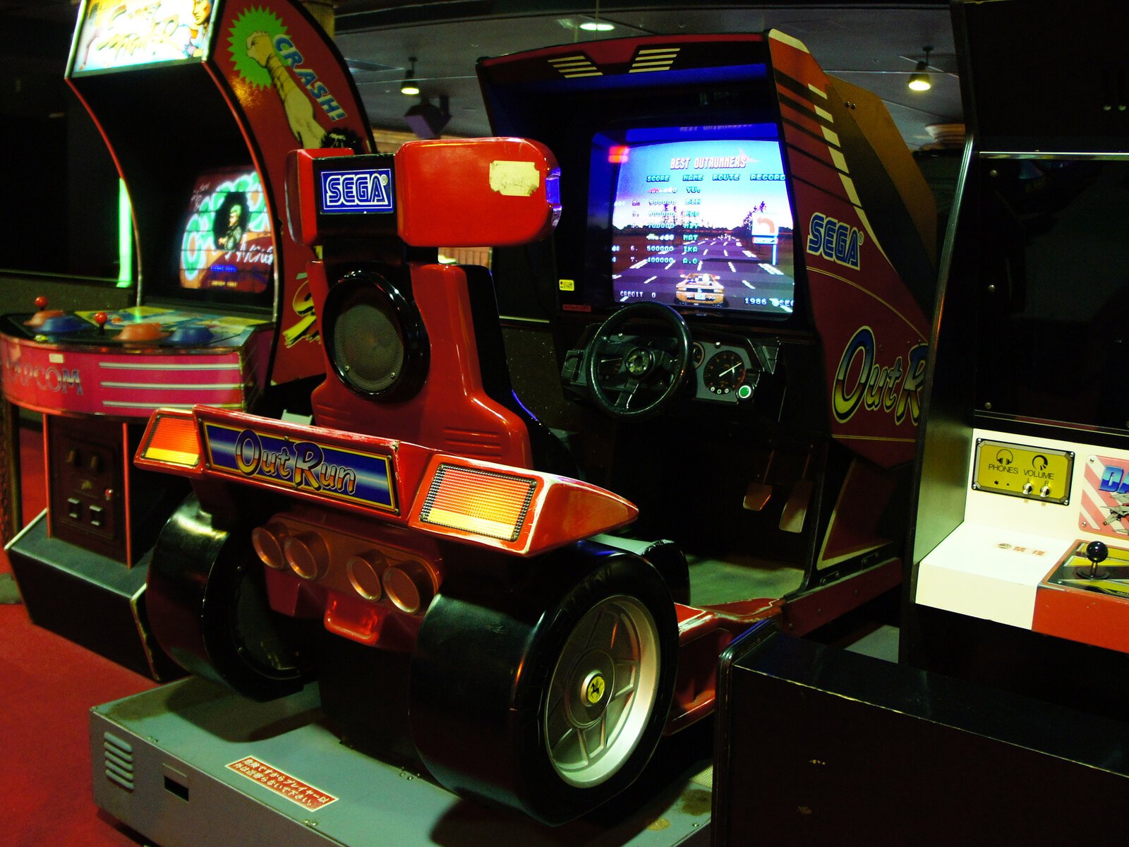 Sega Out Run deluxe sit-down arcade cabinet with the Best Outrunners score screen lit up