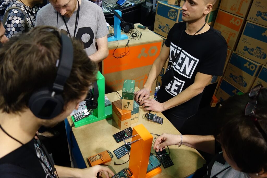 Visitors with headphones trying Teenage Engineering Pocket Operators at the 2015 NAMM Show